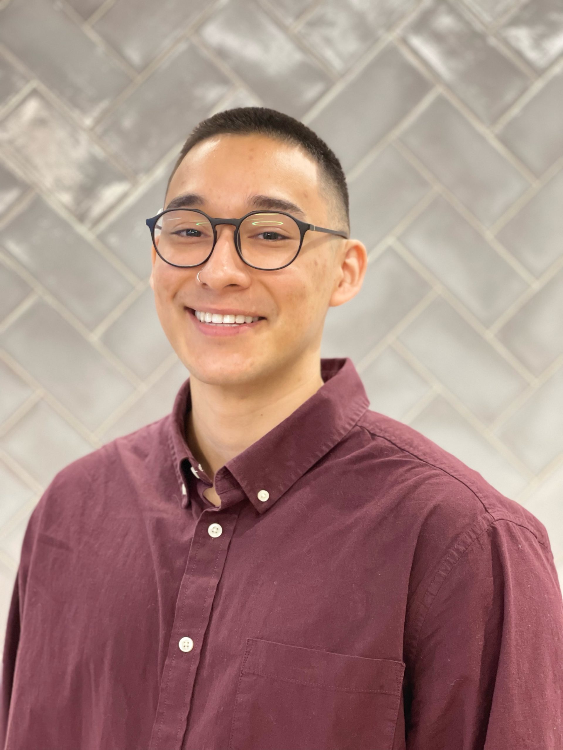 a man smiling for a portrait photo