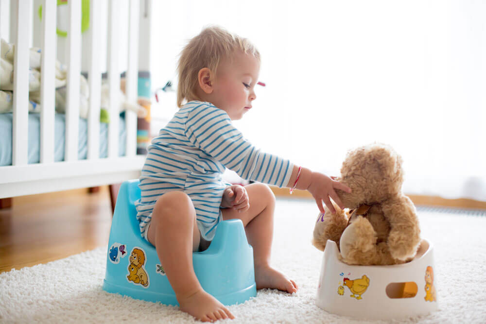 kid sitting on training potty